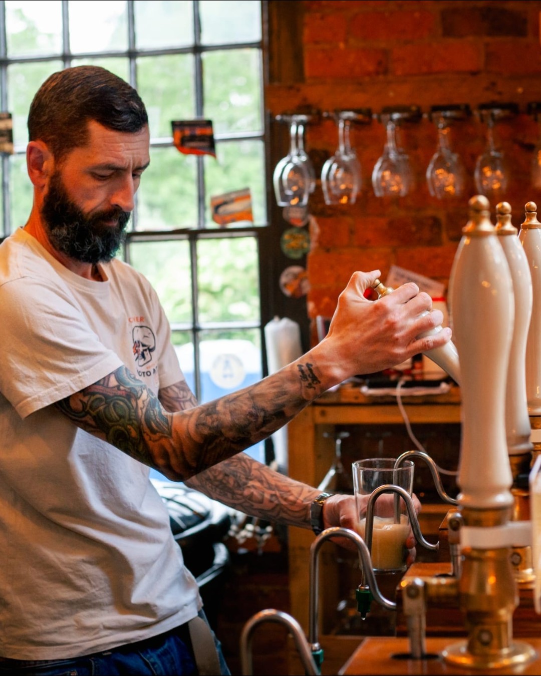 Bartender pouring cask ale at the bar