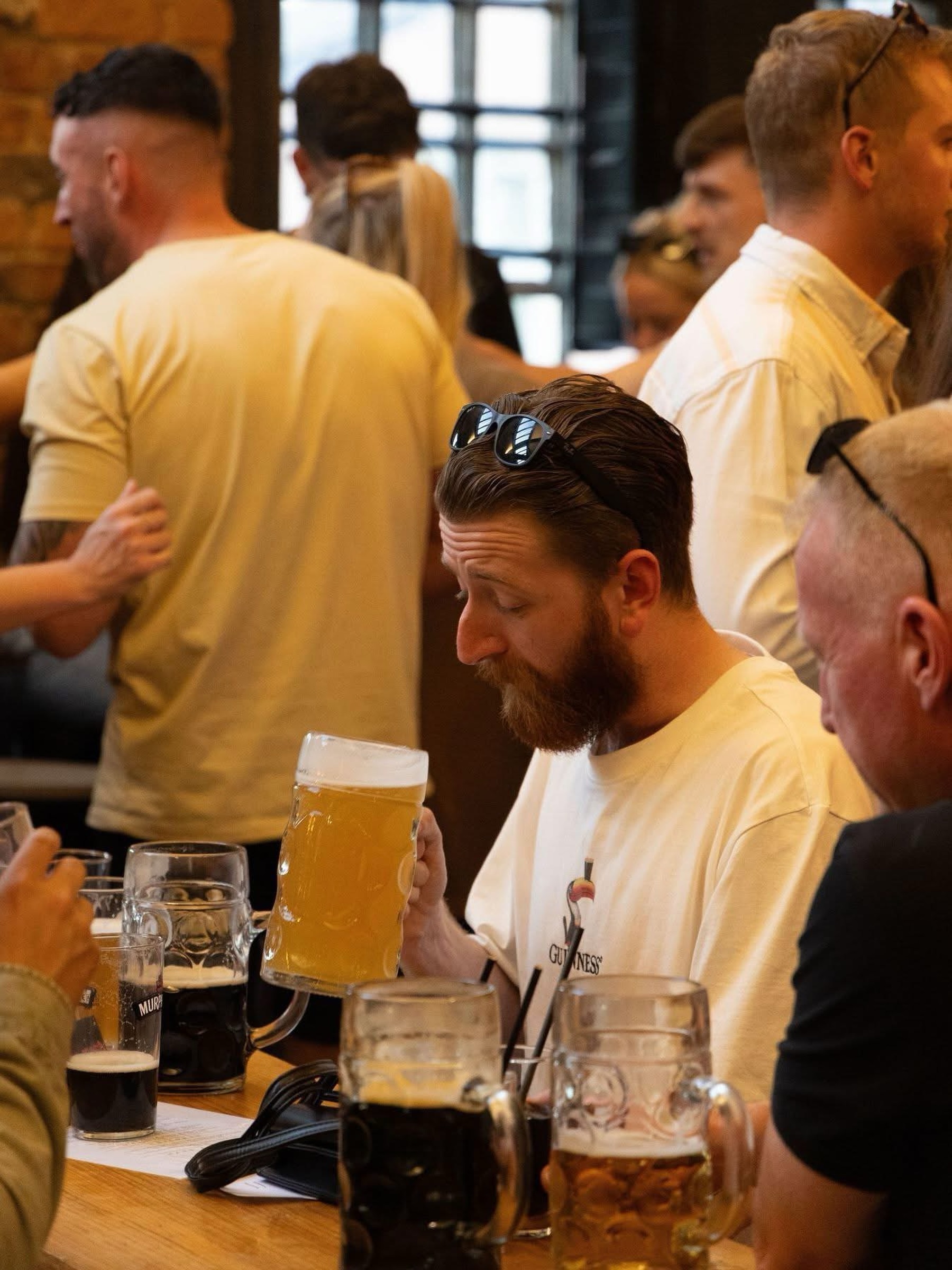 Friends sharing steins of beer at a table