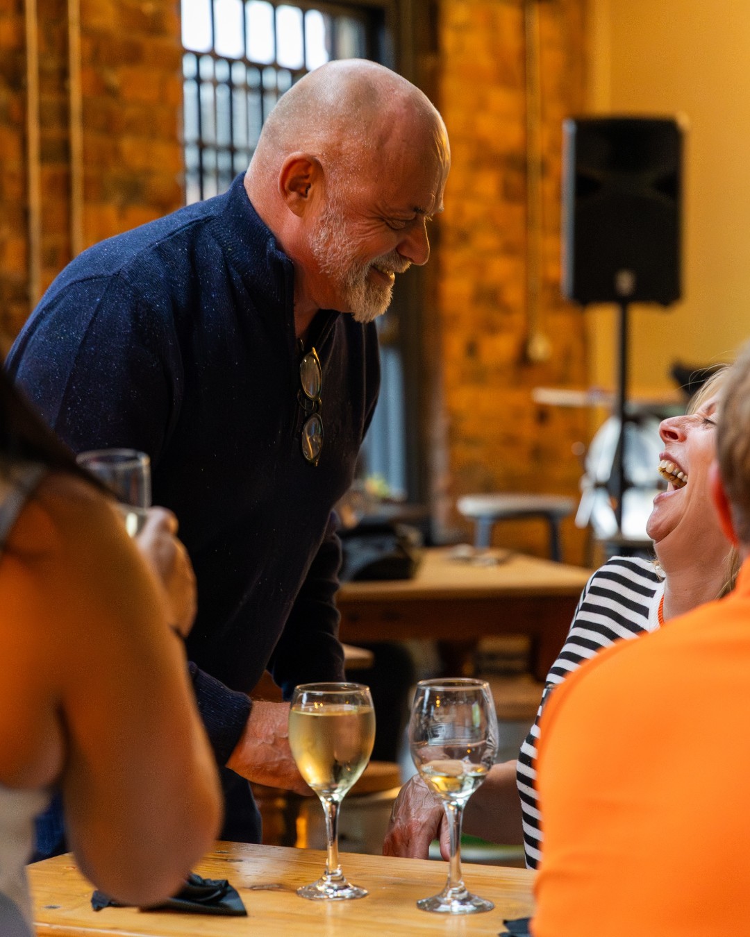 Guests laughing together over drinks